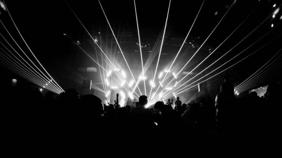 People dancing together at a lively party with colorful ambient lighting synchronized to the music