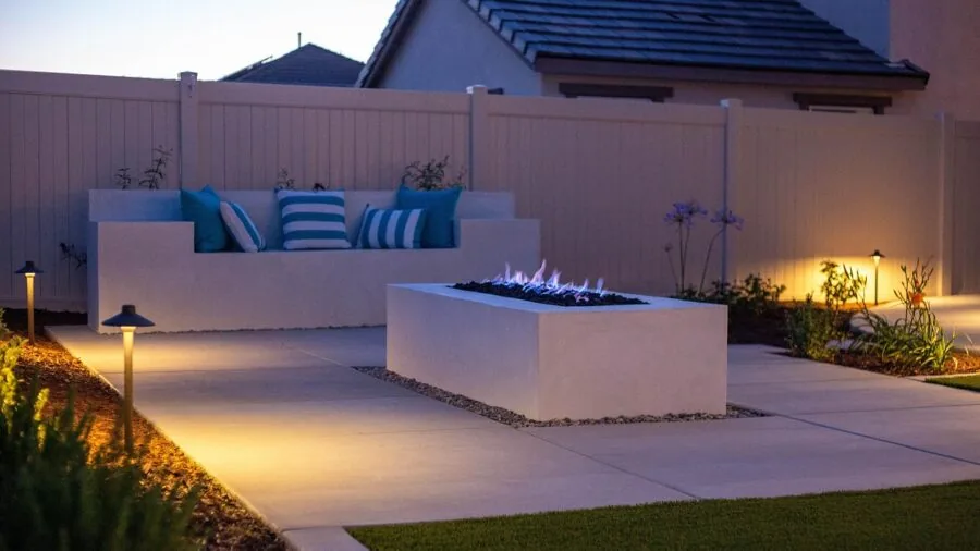 People enjoying a smokeless fire pit in a backyard during evening, showcasing modern outdoor living design