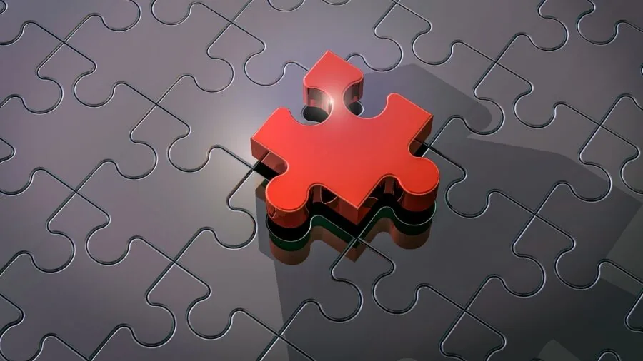 People working together on a complex jigsaw puzzle, focused on placing pieces with concentration and patience