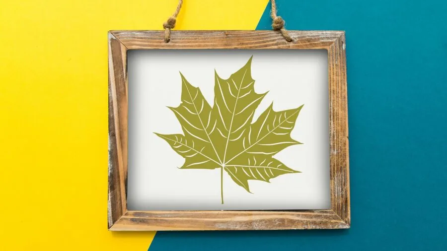Person adjusting framed puzzle art on living room wall with proper mounting hardware