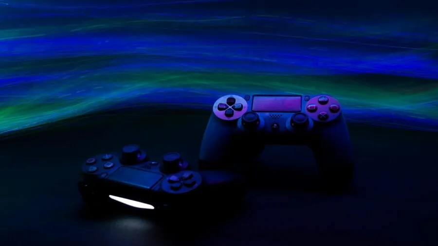 Person adjusting gaming controller buttons at desk during gameplay session