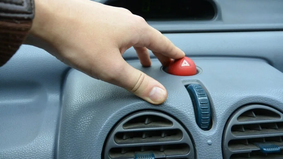 Person adjusting straps on car front seat headrest for backseat organizer installation