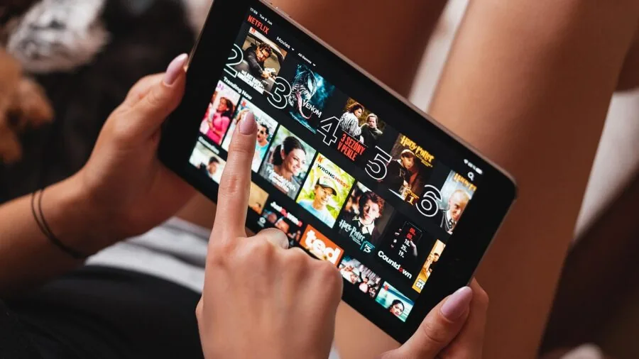 Person adjusting tablet stand angle during daily use, showing real-world positioning and adjustment mechanics