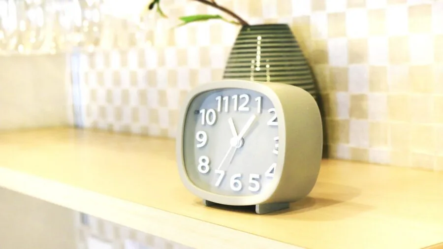 Person adjusting traditional kitchen appliance dial with hand in bright morning kitchen setting