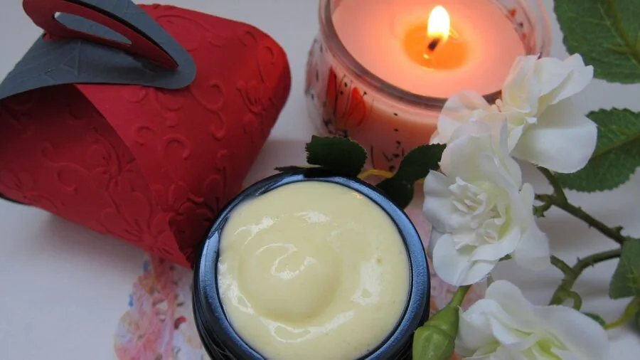 Person applying hand cream with focus on skin hydration and moisturizing texture