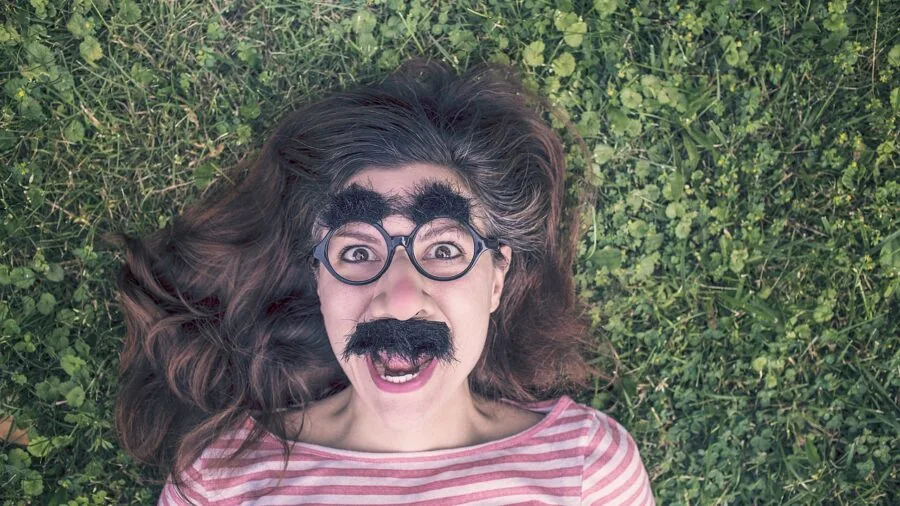 Person applying hydrating sheet mask to face during relaxing skincare routine at home