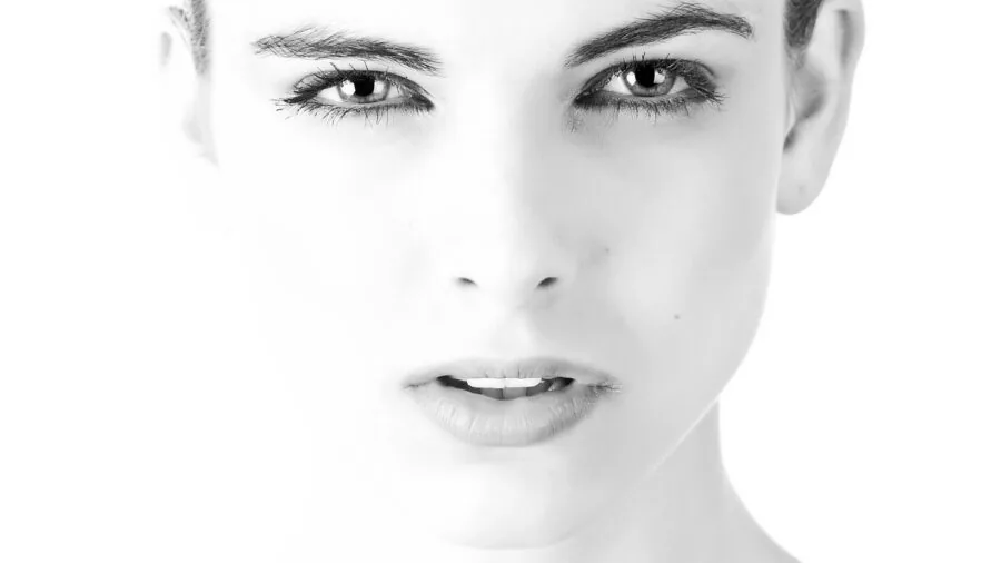 Person applying matte finish powder to face for oil control and long-lasting makeup wear