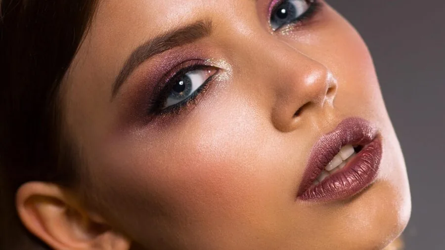 Person applying serum to face during morning skincare routine with natural light