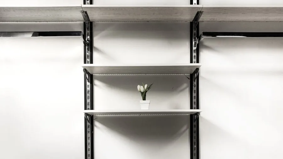 Person arranging collectibles on wall-mounted shelves in bright room