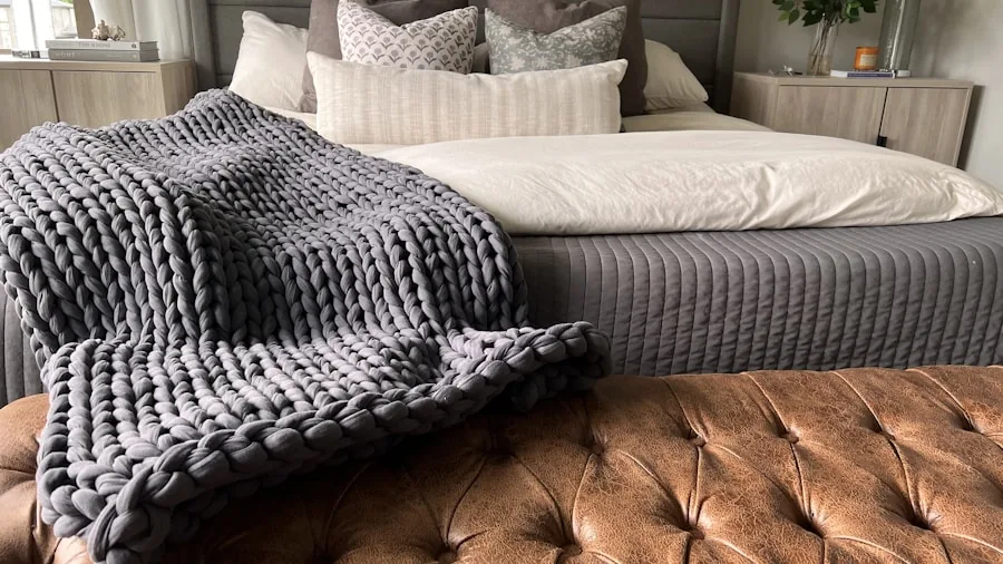 Person arranging different sized blankets on bed to compare coverage options