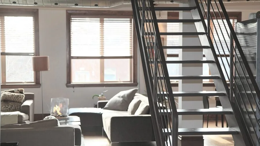 Person arranging modular furniture pieces in a bright living room space