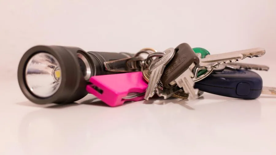 Person arranging multiple keys in pocket, demonstrating everyday key organization and carrying capacity