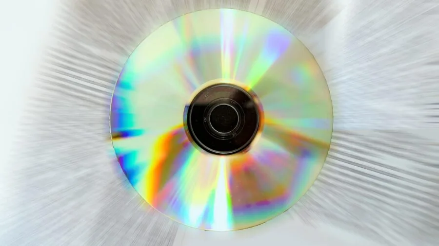 Person arranging music files and storage devices on a workspace desk