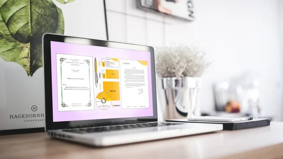 Person building PC with motherboard and components on desk workspace