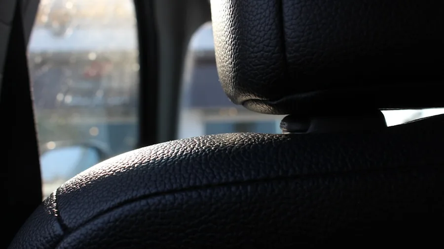 Person carefully adjusting and securing a car seat cover for proper fit and comfort