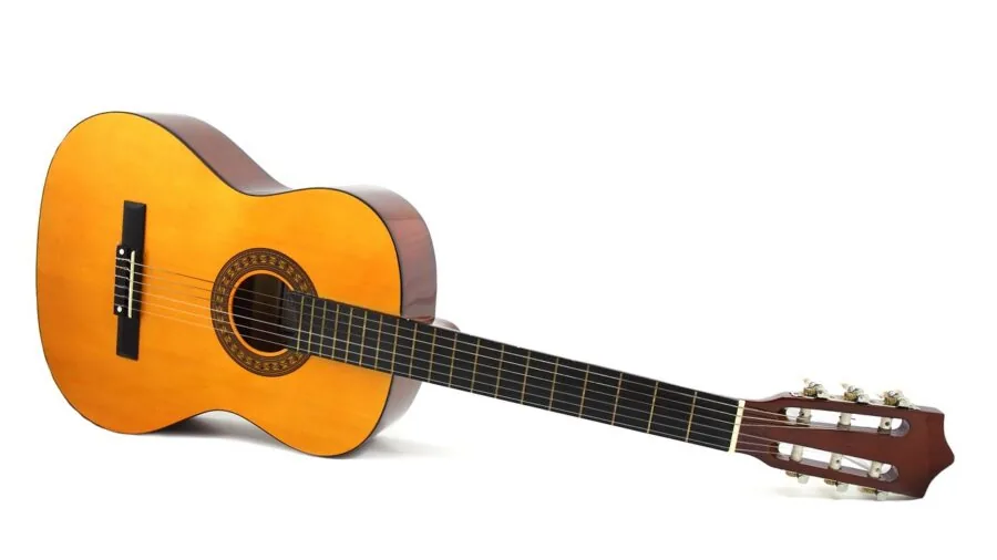 Person carefully adjusting and tuning an acoustic stringed instrument with focused attention to detail