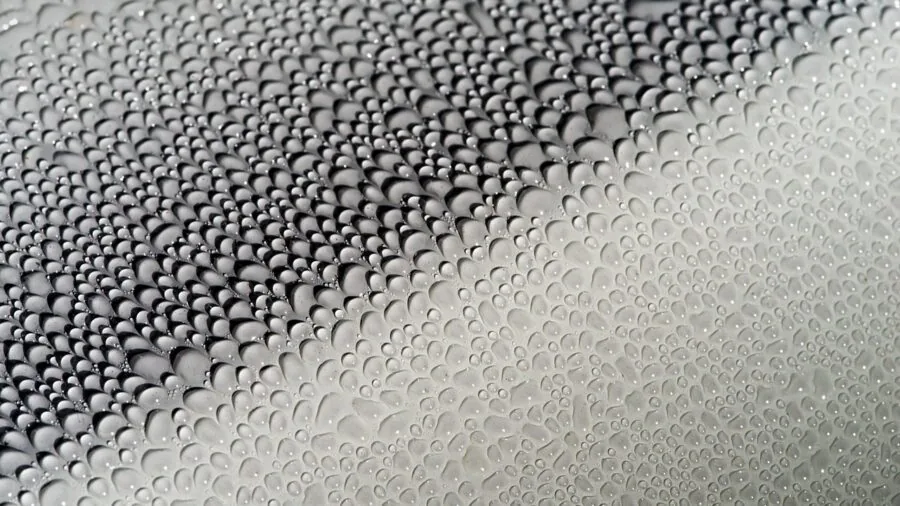Person carefully detailing soft interior surfaces of a car with attention to delicate materials