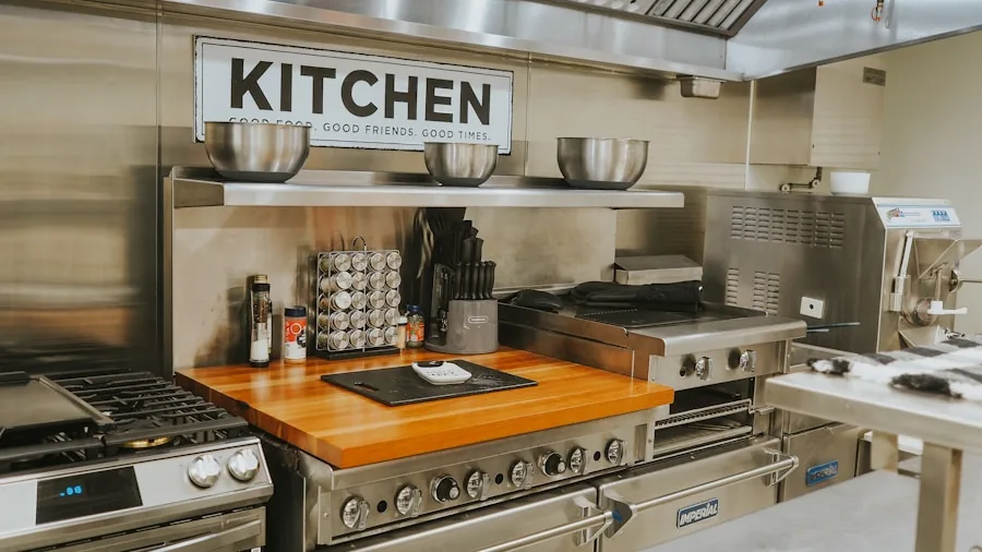 Person carefully examining stainless steel kitchen appliance controls and safety features in home kitchen
