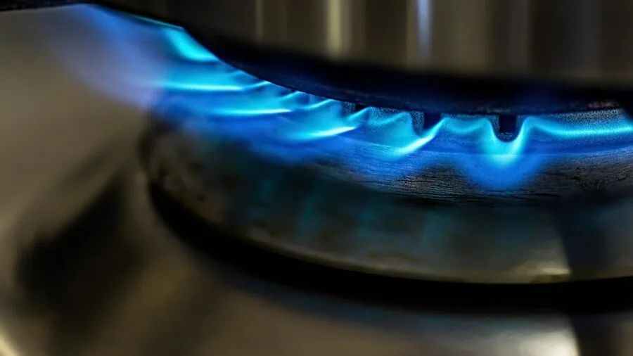 Person carefully handling hot cookware in home kitchen with focused expression