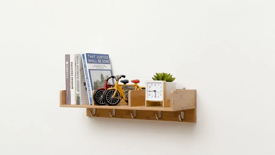 Person carefully installing a wall mount with tools and hardware, focusing on installation process and precision