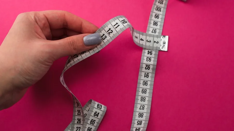 Person carefully measuring sleeve fit on arm to ensure proper compression and comfort