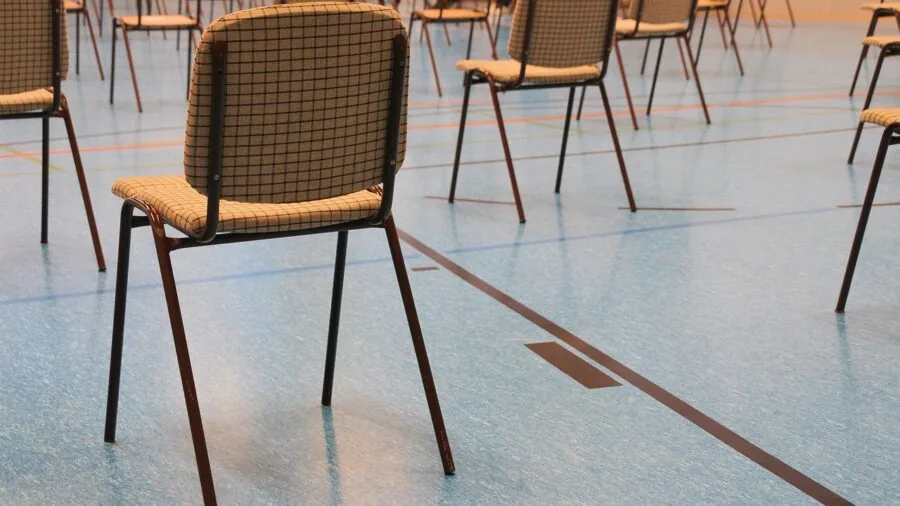 Person carefully opening and inspecting a damaged furniture package with cardboard boxes