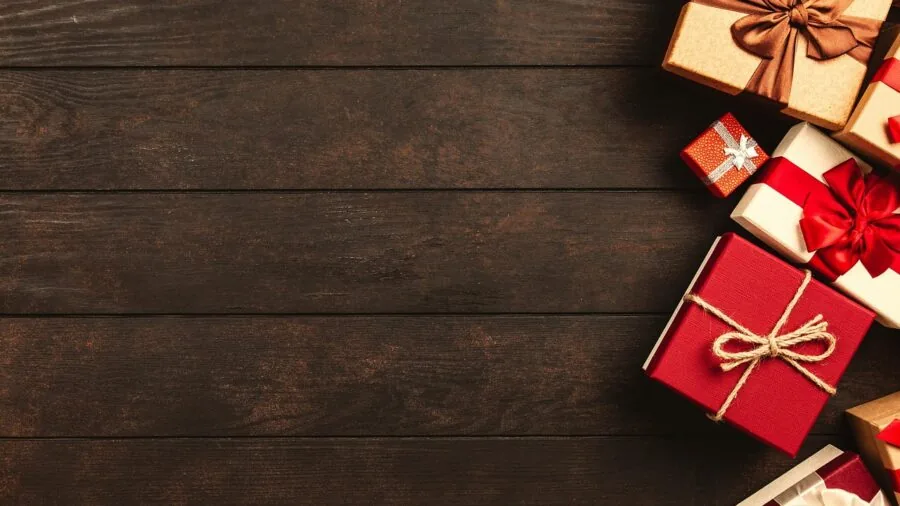 Person carefully opening premium gift box containing wooden puzzle pieces at home