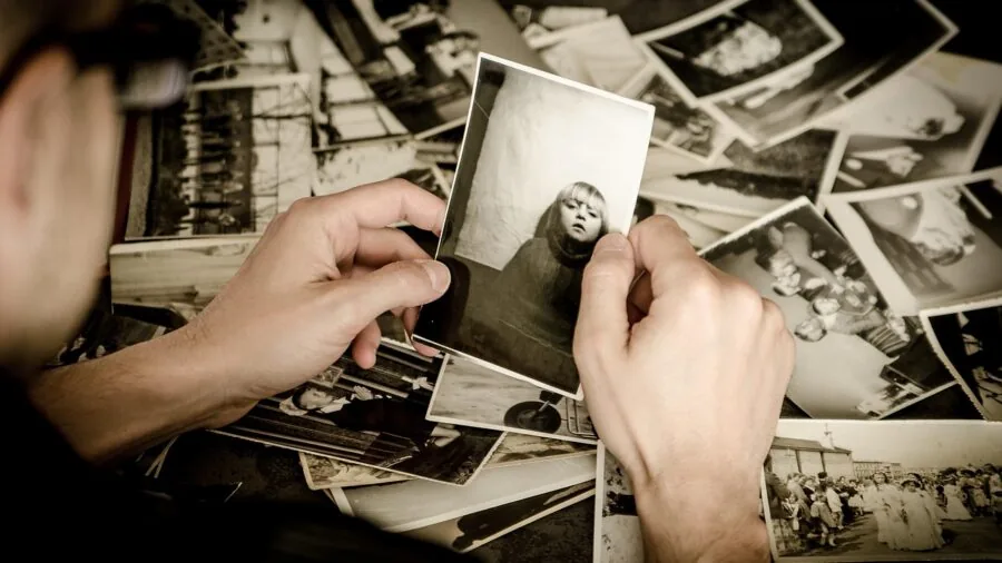 Person carefully organizing and preserving valuable items with protective materials in natural light