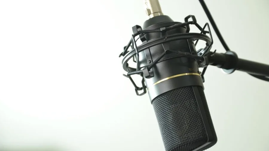 Person carefully reading technical specifications and product documentation while researching audio equipment purchase