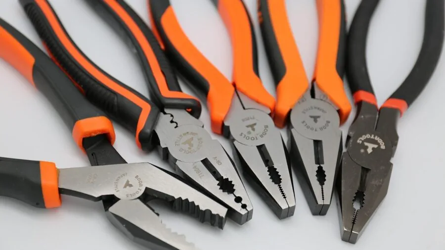 Person carefully repairing and maintaining a garden tool outdoors in natural daylight