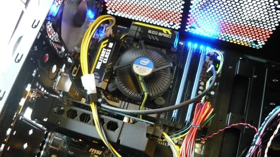 Person carefully selecting computer processor component for system upgrade at workspace