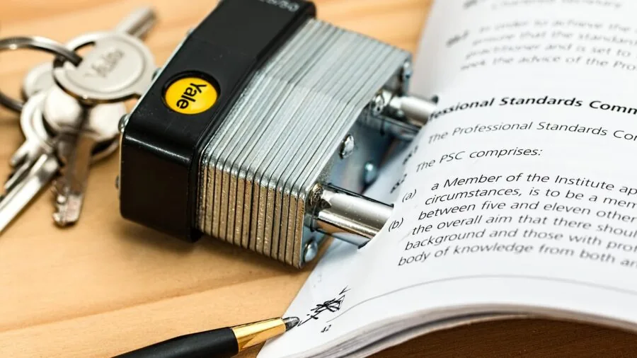 Person carefully sorting and organizing important financial documents and papers on a desk