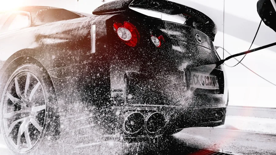 Person carefully washing car exterior to protect paint coating and finish