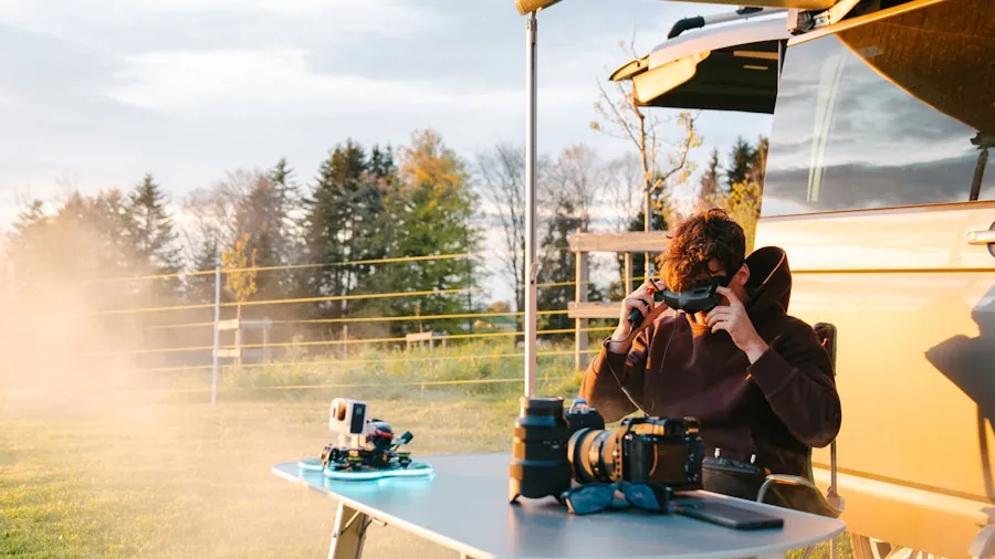 Person charging a battery device outdoors during daytime, representing RC hobby maintenance and preparation