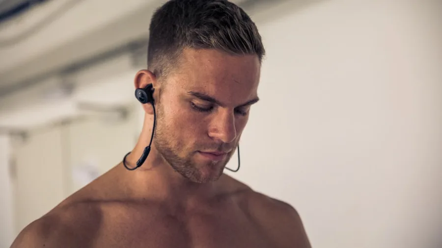 Person charging wireless earbuds before workout session at home