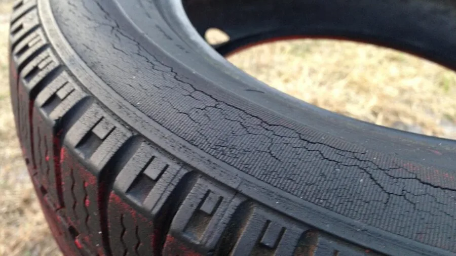 Person checking and maintaining car tire valve stems during routine vehicle maintenance