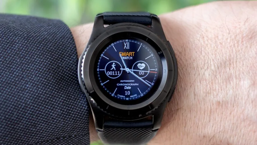 Person checking heart rate monitor during outdoor run recovery with focus on fitness tracking