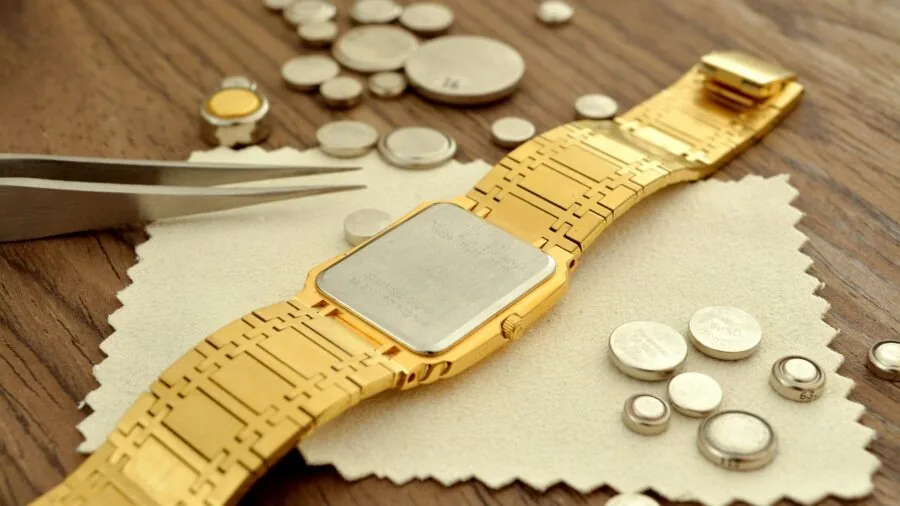 Person checking small battery components for electronic devices in natural lighting