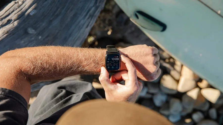 Person checking smartphone battery percentage while outdoors in natural daylight