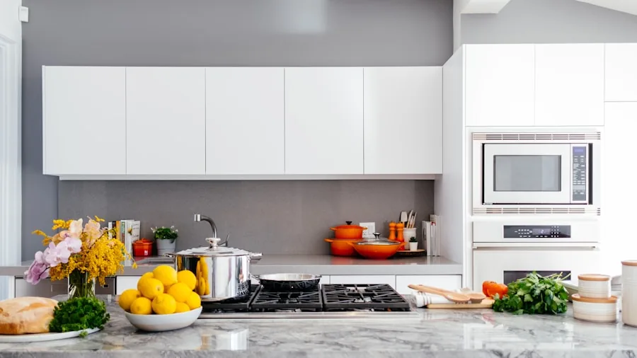 Person choosing between kitchen gadgets on a contemporary countertop