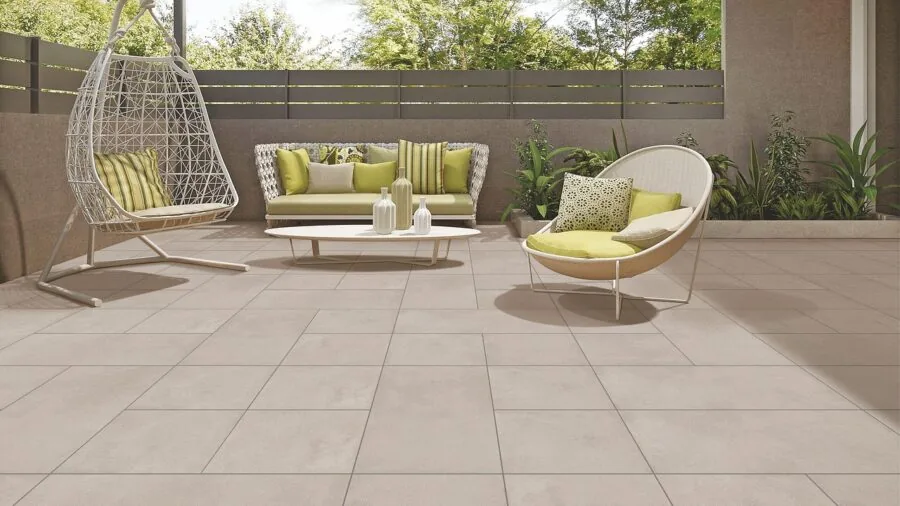 Person cleaning outdoor patio cushions with cloth and water during home maintenance