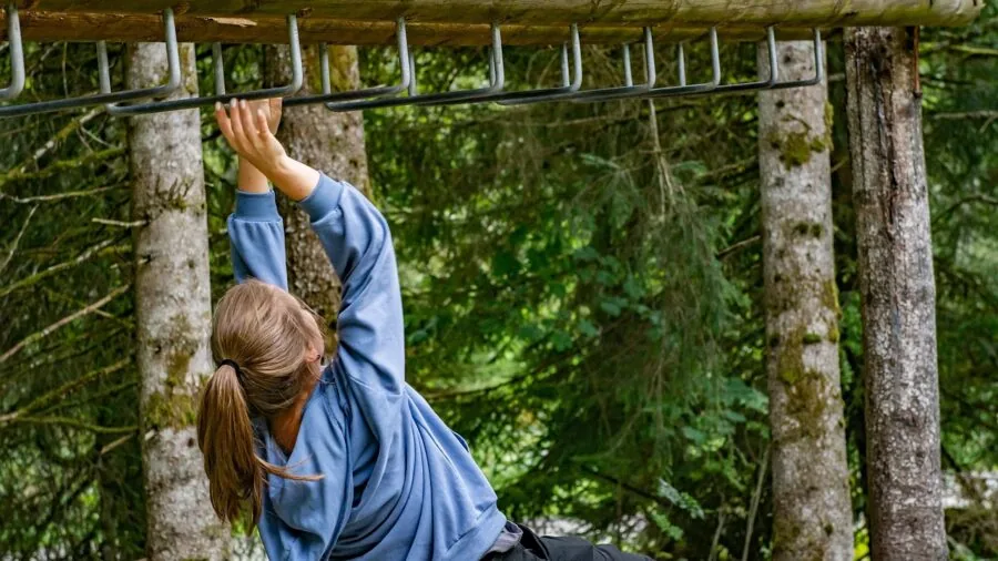 Person climbing outdoor stairs with athletic posture and upper body engagement
