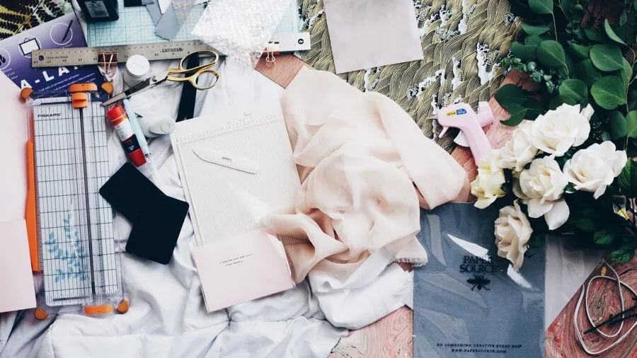 Person comparing different fabric scissors while working on a sewing project at home
