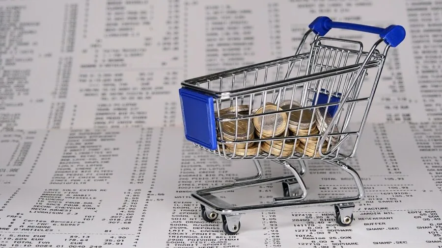 Person comparing kitchen tools and prices while shopping, evaluating options for home cooking needs