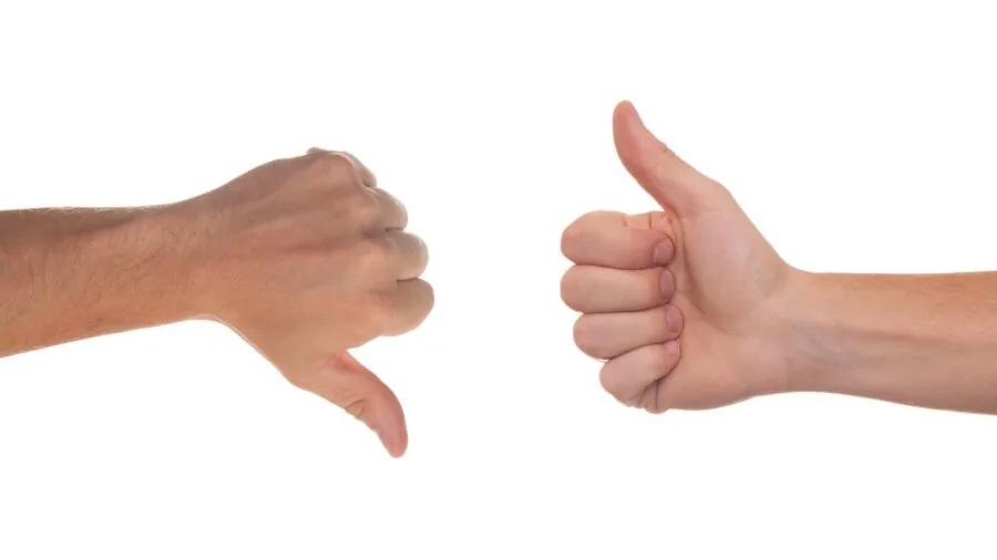 Person comparing price options while shopping, evaluating value and cost differences between products
