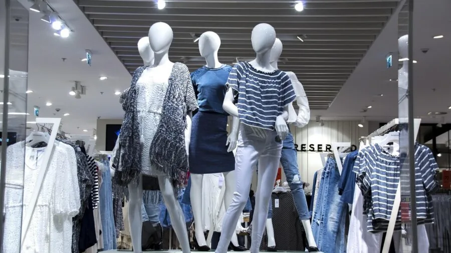Person comparing products and prices while shopping, lifestyle scene with multiple items and budget considerations