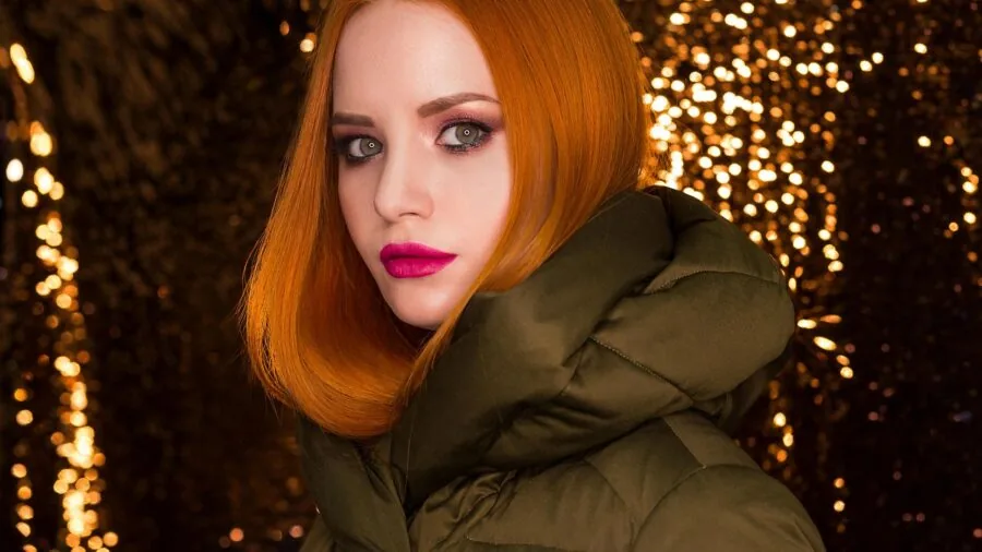 Person comparing winter clothing options in a retail environment, evaluating quality and value