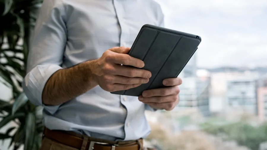 Person confidently carrying tablet while traveling outdoors, emphasizing portable device durability and mobility