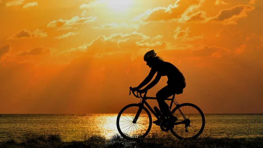 Person cycling on stationary bike trainer indoors during home workout session
