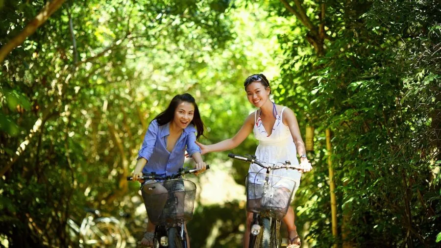 Person cycling through natural landscape on green environmental journey